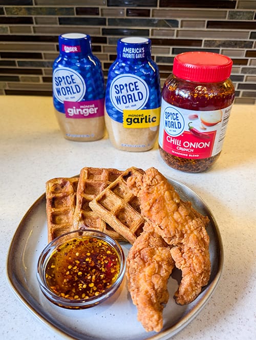 Chicken and waffles served with chili onion crunch and various condiments