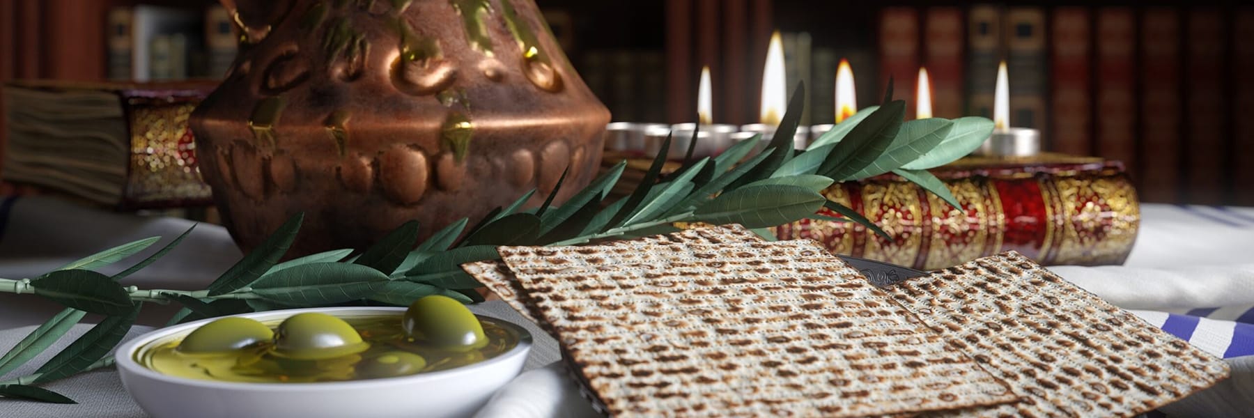 Table set for Jewish pesach passover with books, olives, candles, and a pitcher