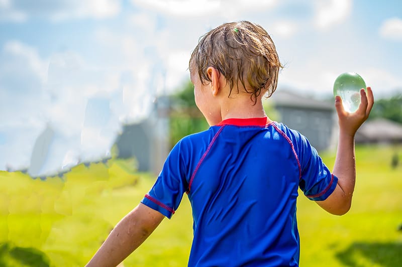 Child enjoying outdoor play with a balloon, not related to food