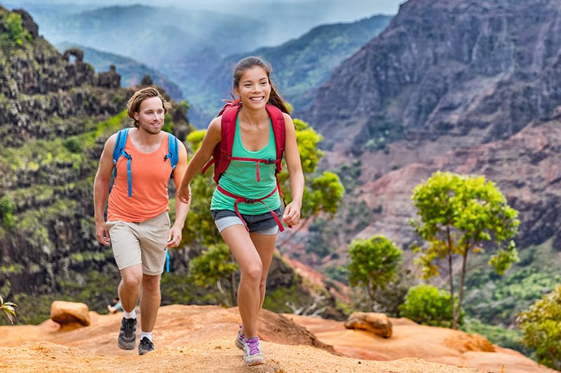 Two hikers enjoying nature on a scenic trail, representing active lifestyle