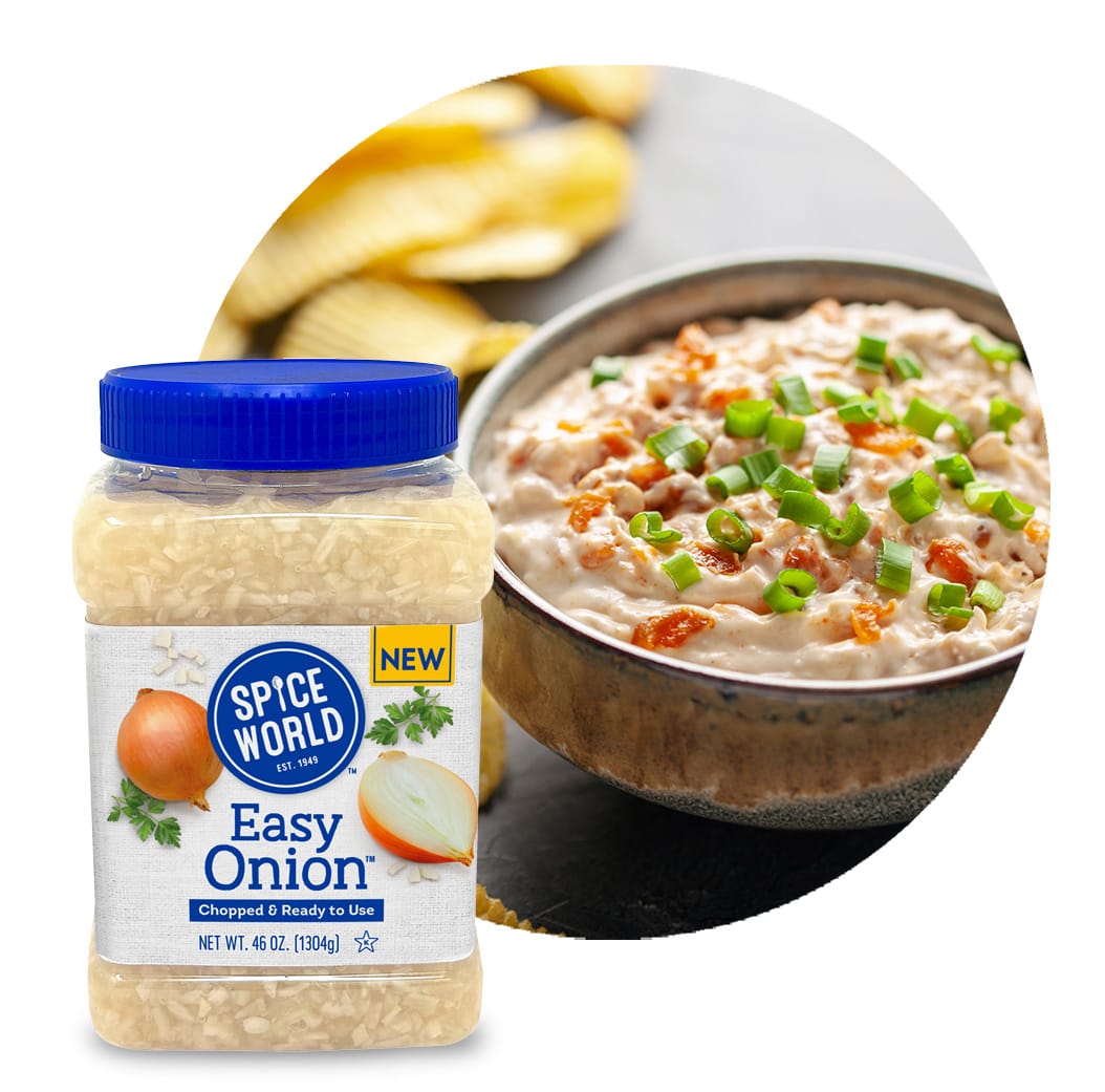 Chopped onions in a jar and a bowl of creamy dip with green onions on top, with crisps in the background