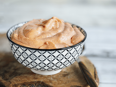 Bowl of creamy dessert mousse on a wooden board, ready to be served