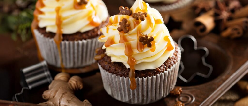 Gourmet cupcakes topped with creamy frosting and caramel drizzle