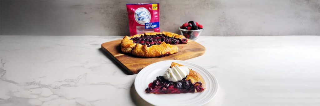 Berry galette served with whipped cream, featured alongside berry packaging and fresh berries
