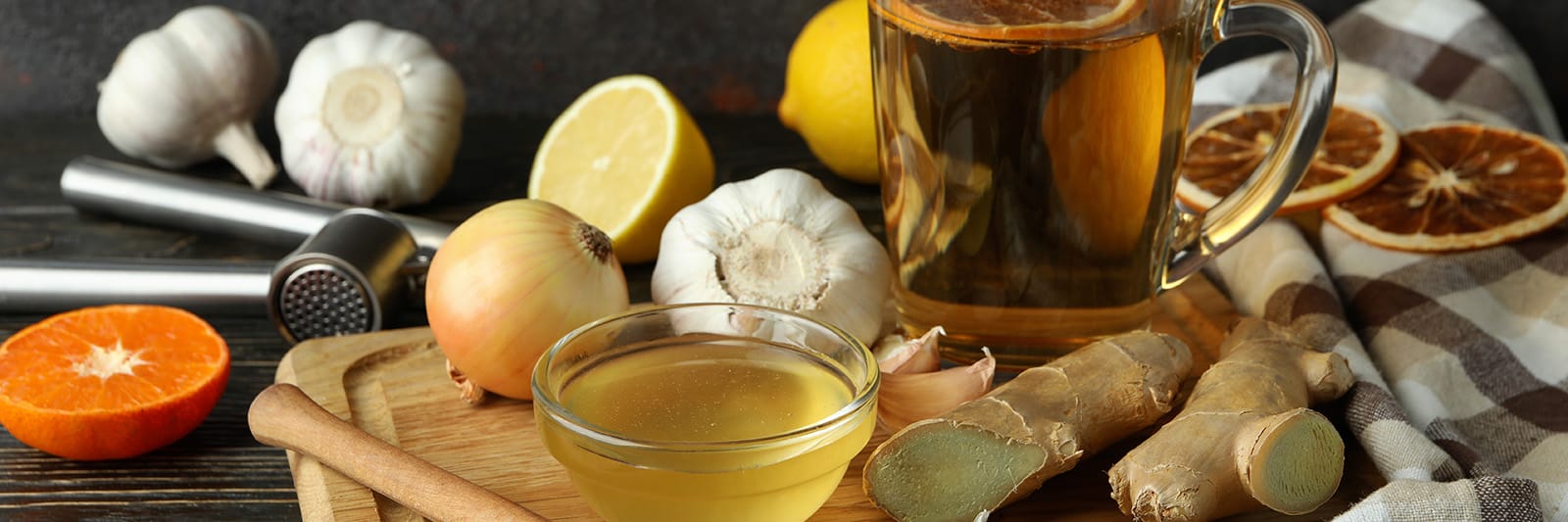 Ingredients for making immunity-boosting hot beverage with honey, garlic, and citrus