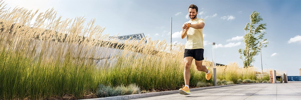 Man jogging on a sunny day, promoting a healthy lifestyle as a key ingredient in leading a joyful life