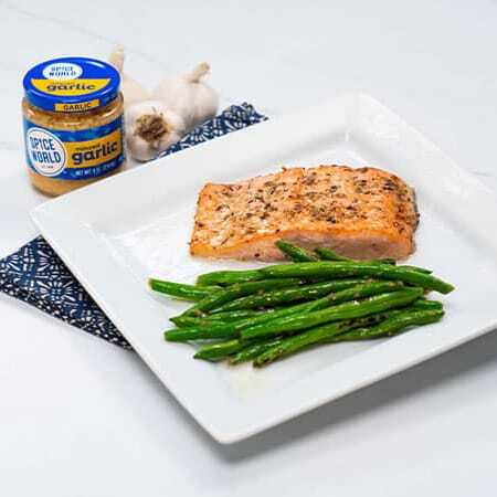 Grilled salmon with asparagus on a plate, served with garlic seasoning