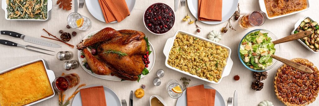 Assorted traditional dishes for a festive meal including roast turkey and sides