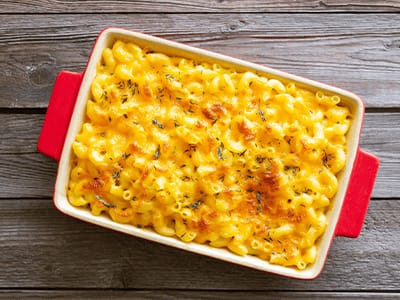 Baked macaroni and cheese in a dish, ready to serve as a comforting and delicious meal