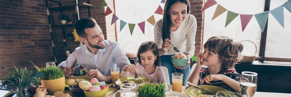 Family gathering around a festive table, sharing delicious food and drinks during a special celebration