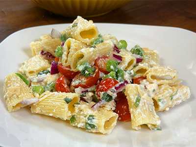 Close-up of a plate of pasta with tomatoes and vegetables, highlighting a delicious meal option