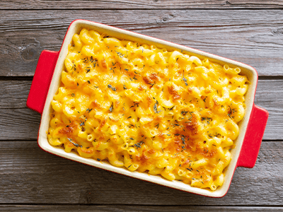 Baked mac and cheese in a red dish, perfect for family gatherings or comfort food inspiration