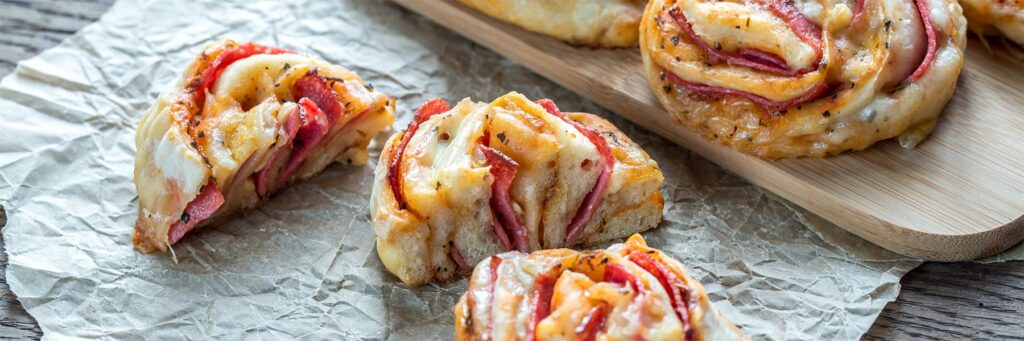 Delicious savory rolls filled with meats and gooey cheese, perfect for a tasty snack or appetizer