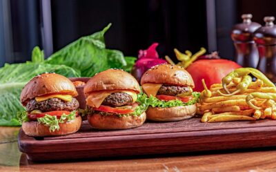 Platter of tasty sliders with lettuce, tomato, and fries, perfect for a casual meal or gathering