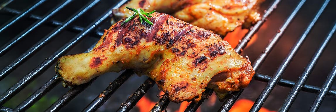 Grilled chicken legs on a barbecue, showcasing delicious outdoor cooking for a flavorful meal